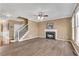 Open-concept living room with hardwood floors, a staircase, and a fireplace with a white mantel at 513 Mirramont Pl, Woodstock, GA 30189
