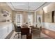 Home office featuring neutral walls, white wainscoting, modern lighting, and a large desk at 513 Mirramont Pl, Woodstock, GA 30189