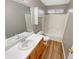 Bright bathroom featuring a combination shower and tub, and stylish wood-look floors at 2328 Wavetree Nw Ln, Acworth, GA 30101