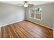 Bedroom with a ceiling fan and wood-look flooring, filled with natural light from the large window at 2328 Wavetree Nw Ln, Acworth, GA 30101