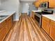 A well-equipped kitchen featuring wood cabinets, stainless steel appliances and quartz countertops at 2328 Wavetree Nw Ln, Acworth, GA 30101