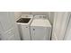 Convenient laundry room featuring a modern, front-load Samsung washer and Whirlpool dryer at 2328 Wavetree Nw Ln, Acworth, GA 30101