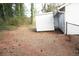 Backyard area features a storage shed for organizing outdoor items and equipment at 5928 Seam St, Lithonia, GA 30058