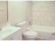 Bright bathroom with marble tile surround, white vanity and toilet at 5928 Seam St, Lithonia, GA 30058