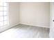 Empty bedroom with vinyl plank flooring, window, and closet at 5928 Seam St, Lithonia, GA 30058