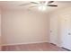 Bedroom with laminate wood floors, ceiling fan, and two doors at 5928 Seam St, Lithonia, GA 30058