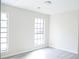 Well-lit bedroom with modern vinyl flooring and large windows at 5928 Seam St, Lithonia, GA 30058