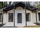 Exterior features a porch and stone accent wall around the front door and windows at 5928 Seam St, Lithonia, GA 30058