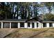 Charming ranch-style home featuring a two-car garage, white siding, and well-manicured landscaping at 5928 Seam St, Lithonia, GA 30058