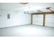 Clean and empty garage with a painted floor and two car garage door at 5928 Seam St, Lithonia, GA 30058