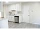 Kitchen with gray wood-look flooring and stainless steel dishwasher at 5928 Seam St, Lithonia, GA 30058