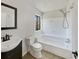 Bright bathroom featuring a tub and shower combination at 901 Chapman Cir, Stone Mountain, GA 30088