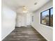 This bedroom features hardwood flooring, a ceiling fan and a large window at 901 Chapman Cir, Stone Mountain, GA 30088