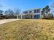 Split-level home featuring two-car garage, neutral colors, and large windows at 901 Chapman Cir, Stone Mountain, GA 30088