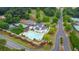 Aerial shot of a community center with a large swimming pool and tennis courts next to a quiet road at 12 Ridgeline Nw Way, Cartersville, GA 30121