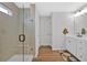 Modern bathroom with glass enclosed shower, white cabinets and wood look floor at 12 Ridgeline Nw Way, Cartersville, GA 30121