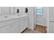 Modern bathroom with double sinks, sleek white cabinets, and wood-look flooring at 12 Ridgeline Nw Way, Cartersville, GA 30121