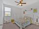 Cozy bedroom featuring a patterned quilt, white furniture and a ceiling fan at 12 Ridgeline Nw Way, Cartersville, GA 30121