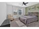 Bright bedroom featuring a ceiling fan, two windows, a bed with unique headboard, and comfortable chair at 12 Ridgeline Nw Way, Cartersville, GA 30121