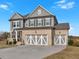 Beautiful two-story home featuring a brick facade, gray siding and a three-car garage at 12 Ridgeline Nw Way, Cartersville, GA 30121