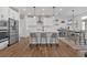 Bright, modern kitchen with white cabinets, stainless steel appliances, island, and breakfast area at 12 Ridgeline Nw Way, Cartersville, GA 30121