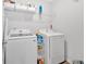 Functional laundry area with modern machines, overhead shelving, and practical storage solutions at 12 Ridgeline Nw Way, Cartersville, GA 30121