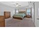 Spacious main bedroom with tray ceiling, ceiling fan, and ensuite bathroom at 12 Ridgeline Nw Way, Cartersville, GA 30121
