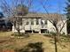 View of the home's backyard with bare trees and a deck at 140 Thrasher Rd, Covington, GA 30016