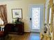 Entryway featuring a stylish door with decorative glass, laminate floors, and decorative mirror at 140 Thrasher Rd, Covington, GA 30016