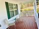 Inviting front porch with chairs, offering a pleasant outdoor seating area with view of front yard at 140 Thrasher Rd, Covington, GA 30016