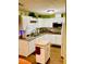 Bright kitchen with white cabinets, granite countertops, stainless steel appliances, and laminate floors at 140 Thrasher Rd, Covington, GA 30016