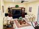Living room boasts comfortable seating, a ceiling fan, and an entertainment center, creating a relaxing atmosphere at 140 Thrasher Rd, Covington, GA 30016
