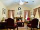 Cozy living room featuring vaulted ceilings, a ceiling fan, and a decorative fireplace at 140 Thrasher Rd, Covington, GA 30016