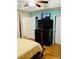 Bedroom with a four poster bed, wooden floors and large TV at 140 Thrasher Rd, Covington, GA 30016