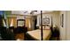 Spacious bedroom with a four poster bed, ceiling fan, and hardwood floors at 140 Thrasher Rd, Covington, GA 30016