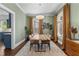 Bright dining room with wood table, stylish light fixture, hardwood floors, and large windows at 267 Connecticut Ne Ave, Atlanta, GA 30307