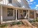 Inviting covered front porch featuring classic white columns, wooden flooring, and rocking chairs at 267 Connecticut Ne Ave, Atlanta, GA 30307