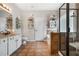 Well-lit bathroom with a shower, bathtub, decorative shelves, and tiled floors at 330 Abbey Ct, Canton, GA 30115