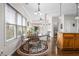 Charming eat-in kitchen area with a round dining table, floral rug, and large windows, offering ample natural light at 330 Abbey Ct, Canton, GA 30115