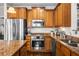 Gourmet kitchen features stainless steel appliances, granite counters, wooden cabinetry, and a central island at 330 Abbey Ct, Canton, GA 30115