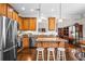 Well-equipped kitchen with stainless steel appliances, wooden cabinets, granite countertops, and a central island with bar seating at 330 Abbey Ct, Canton, GA 30115