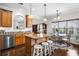 Bright eat-in kitchen featuring wooden cabinets, stainless steel appliances, a central island, and a dining area with large windows at 330 Abbey Ct, Canton, GA 30115
