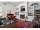 Elegant living room featuring a stone fireplace, built-in bookshelves, and hardwood floors at 330 Abbey Ct, Canton, GA 30115