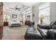 Spacious main bedroom with tray ceilings, a ceiling fan, and a comfortable seating area at 330 Abbey Ct, Canton, GA 30115
