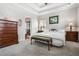 Serene main bedroom with a tray ceiling, soft lighting, and a view into the ensuite bathroom at 330 Abbey Ct, Canton, GA 30115