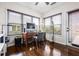 Well-lit home office with a traditional wooden desk, ample natural light from large windows, and hardwood floors at 330 Abbey Ct, Canton, GA 30115