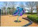 Community playground with a slide, climbing structures, and seating area at 330 Abbey Ct, Canton, GA 30115
