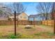 Wide backyard featuring a wood fence, a stone fire pit, and well-maintained grass at 3925 Keystone Nw Rdg, Acworth, GA 30101