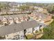 Aerial view of townhomes with manicured landscaping, attached garages, and proximity to roads and wooded areas at 2286 Emerald Sky Dr, Smyrna, GA 30080