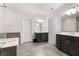 Spacious bathroom with double vanities, wood-look tile flooring and a separate shower and bathtub at 2286 Emerald Sky Dr, Smyrna, GA 30080